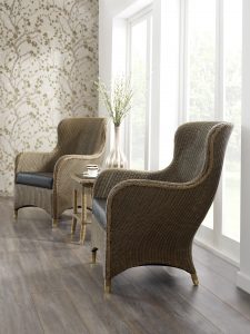two cane furniture chairs situated between a table